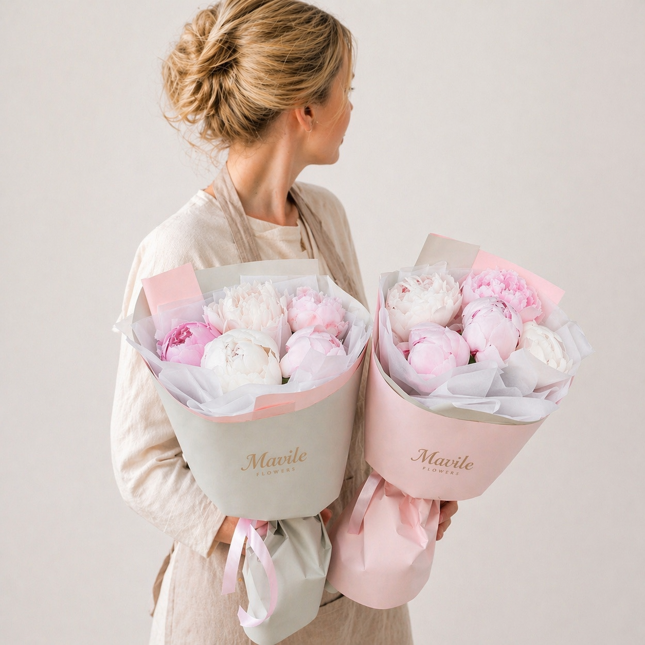 Fresh pink and white flower bouquets held by person featuring sg pure fresh flower arrangement by FSMIA