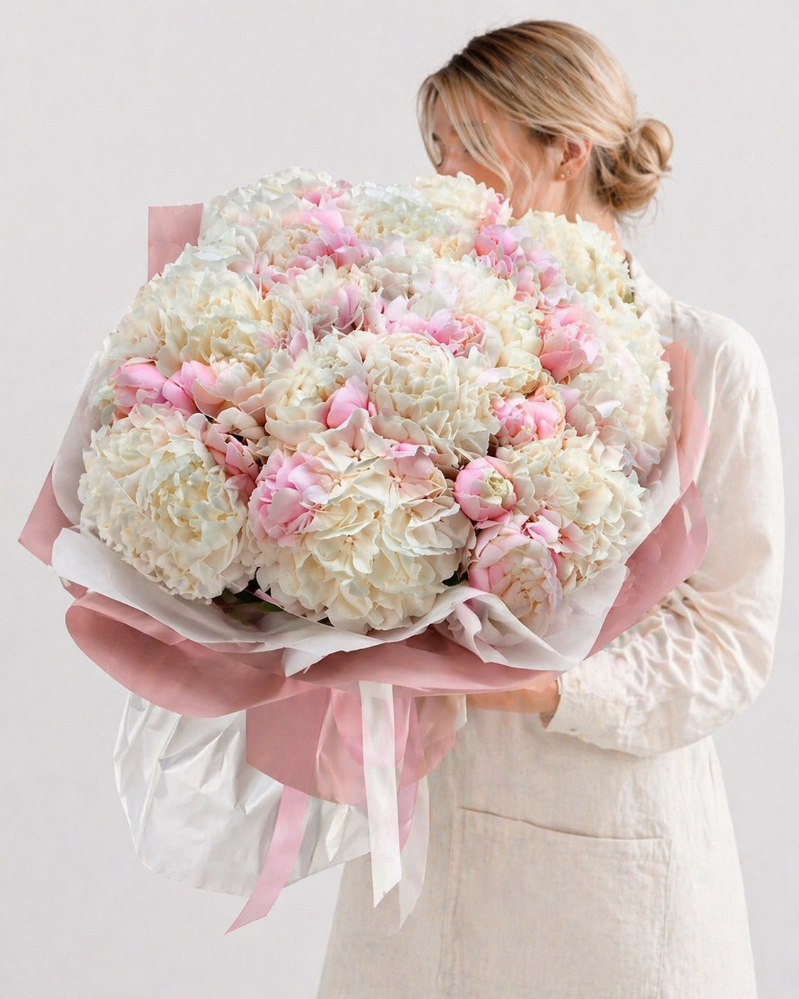 FSMIA fresh flower arrangement featuring large white and pink orlando bloom flowers wrapped in pink paper
